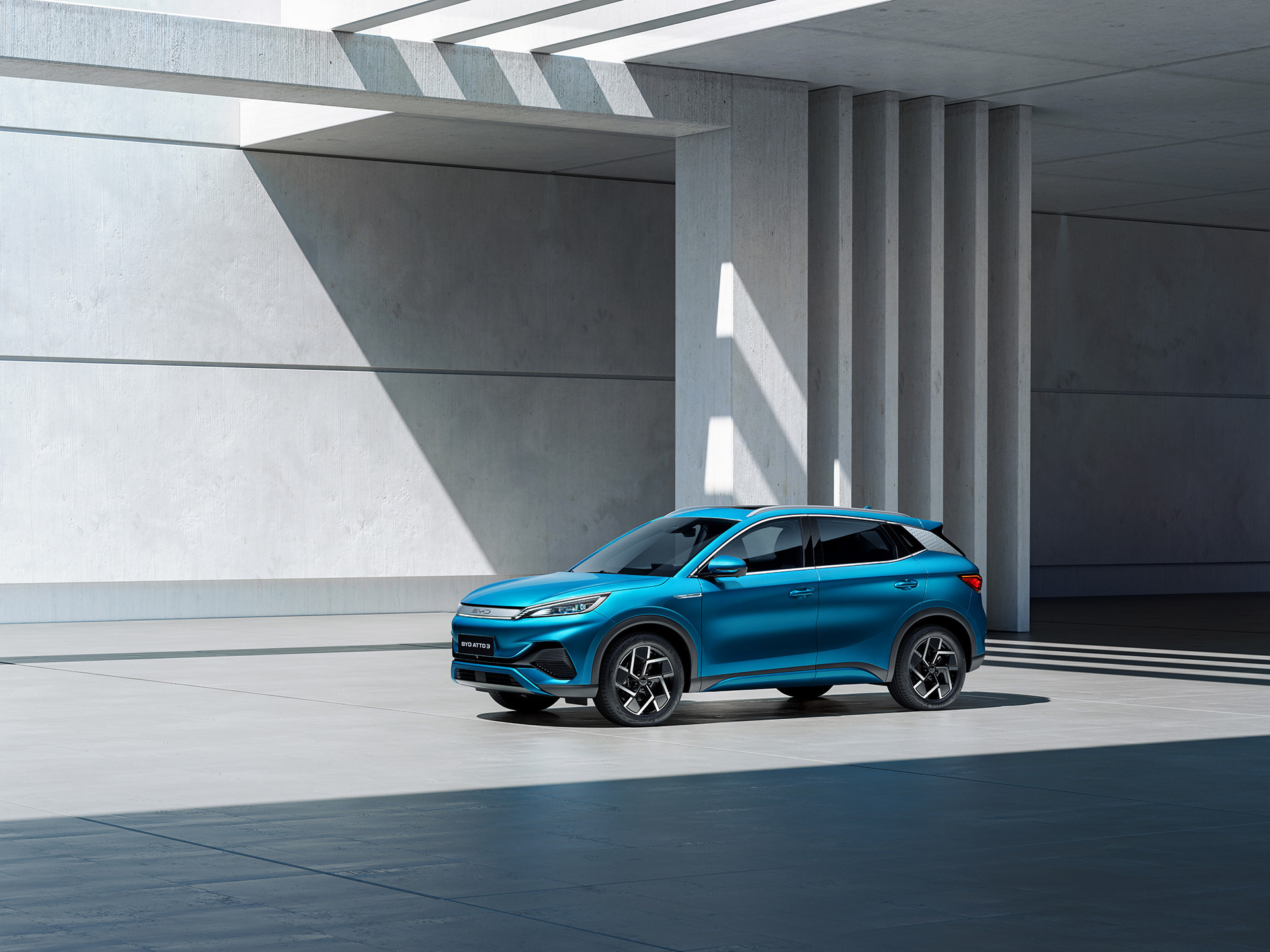 A Surfing Blue BYD ATTO 3 parked in a light filled room